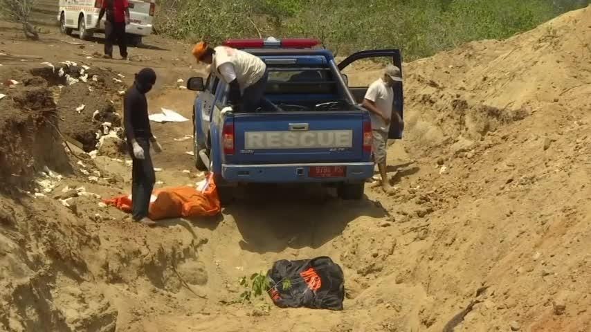 Indonesia Quake Victims Buried In Mass Grave