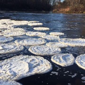 Spinning snow and ice circles grace a local waterway